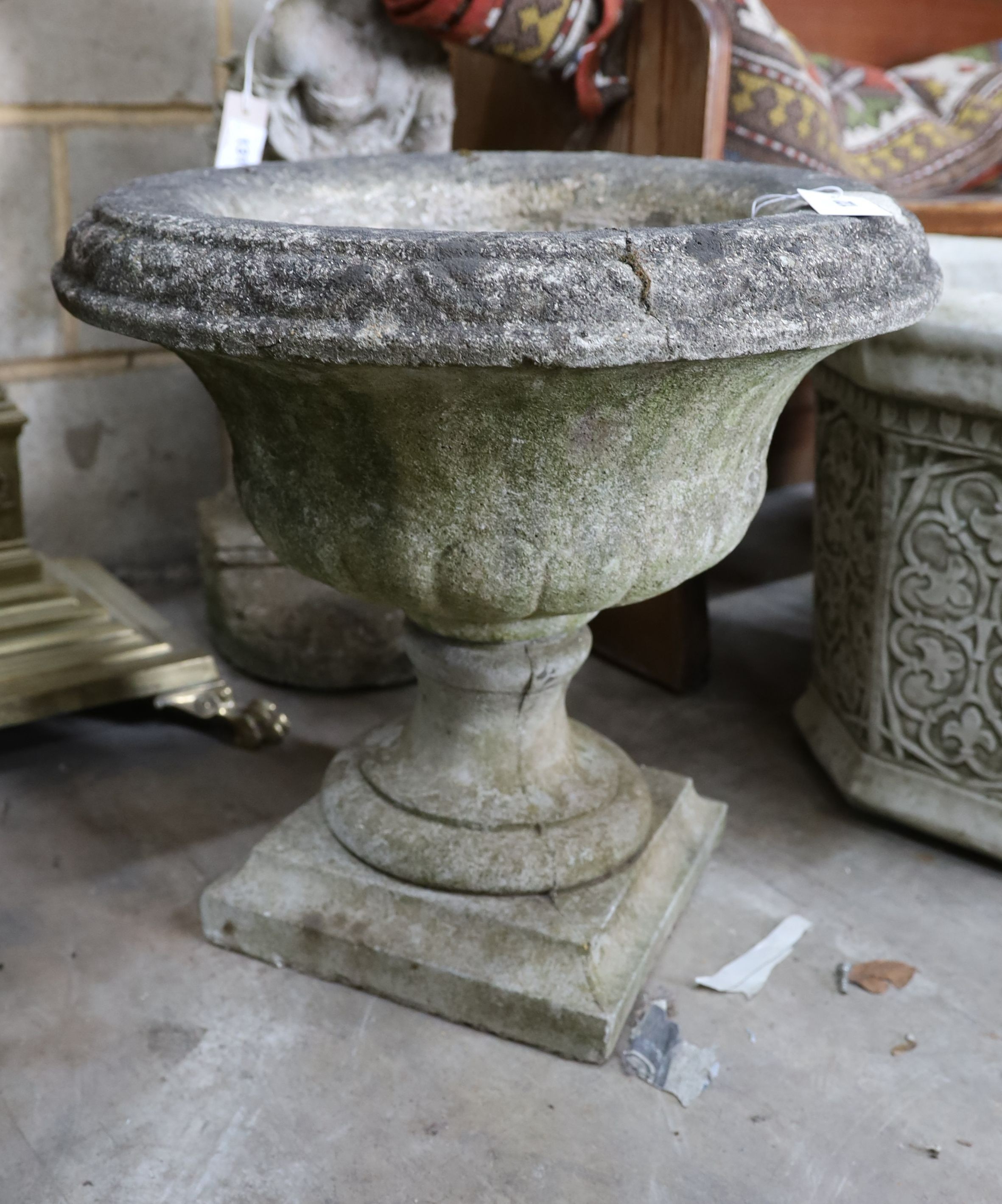 A reconstituted stone campana garden urn, diameter 50cm, height 48cm